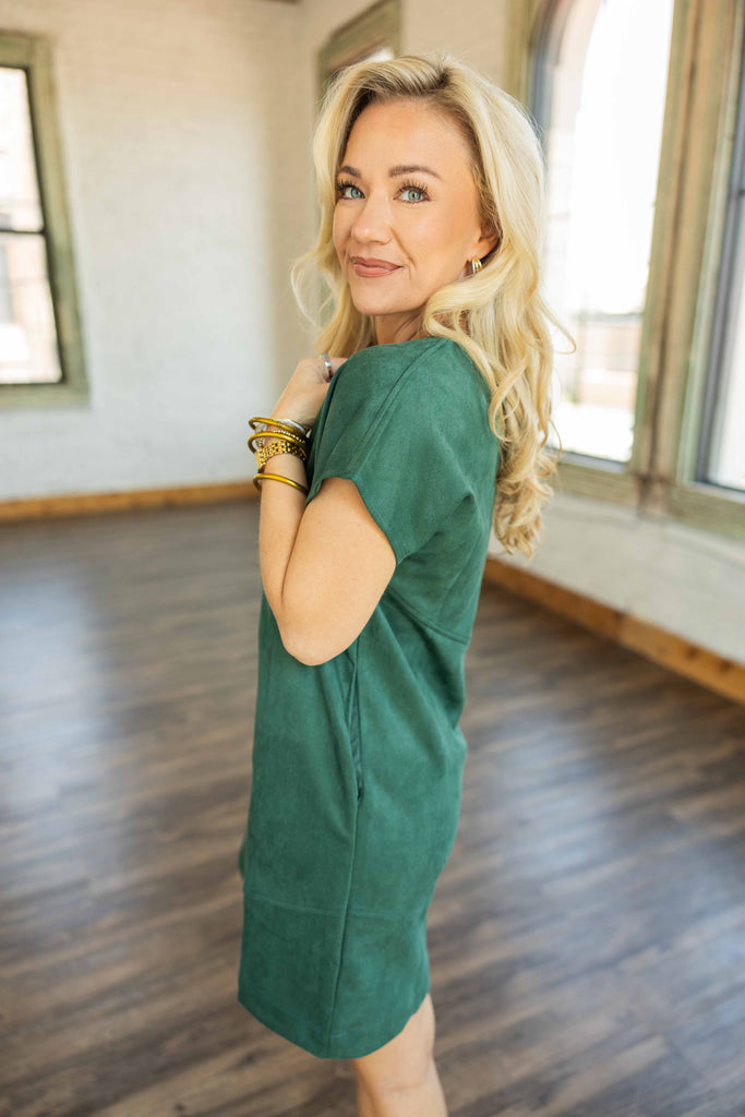 Holly wearing the Nicole Suede Shift Mini Dress in rich green with cap sleeves, suede-like finish, and side pockets