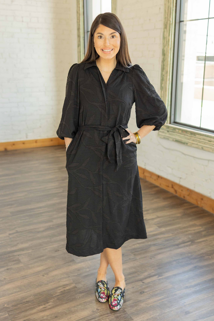 wearing the black Lily textured 3/4 sleeve button front midi dress with waist tie belt and floral loafers