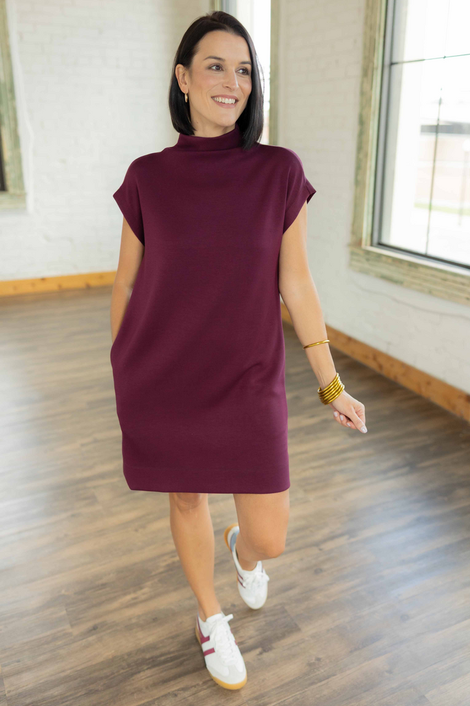 Kandace wearing the Eva plum MAROON pullover mini dress with mock neck, cap sleeves, and white sneakers