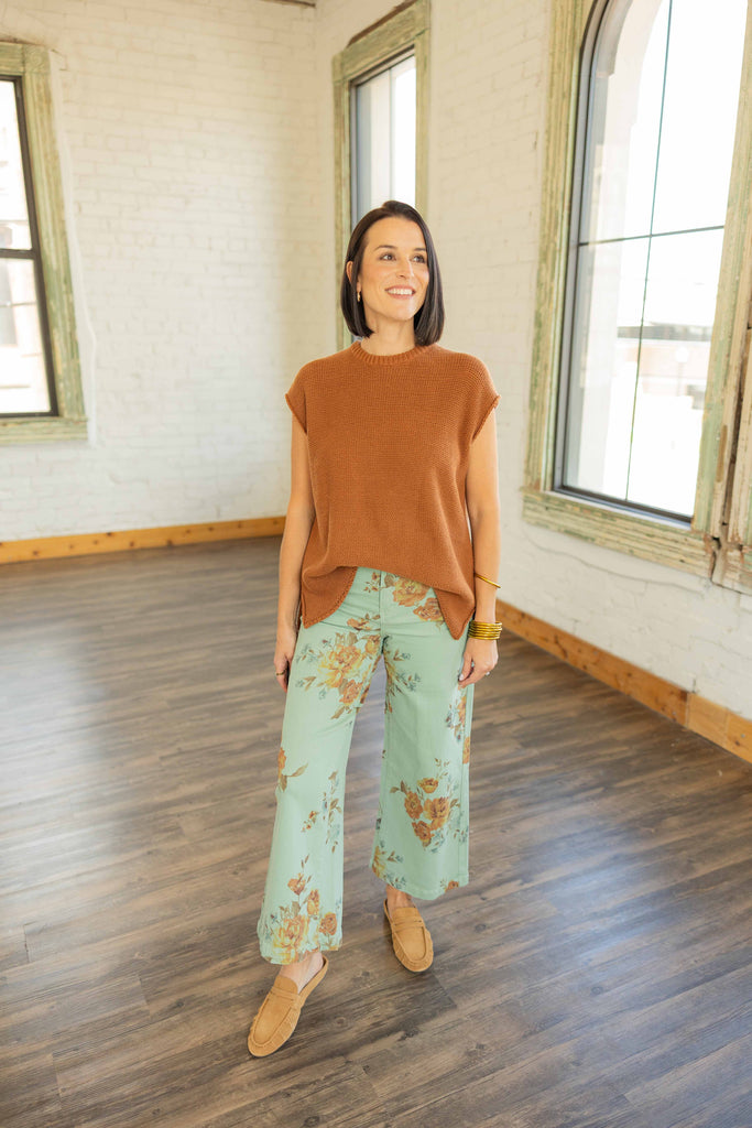 Kandace wearing the Eloise cap sleeve knit sweater top in caramel brown with a relaxed fit, styled with mint floral pants