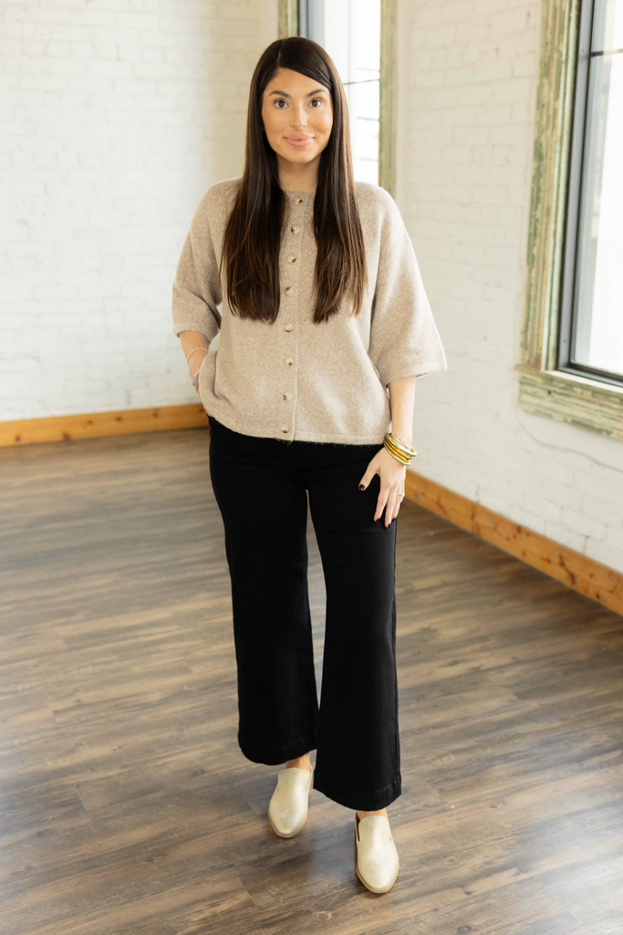 Kayla wearing the Risen Maria high rise ankle wide leg jeans in solid black denim with beige sweater and ivory loafers