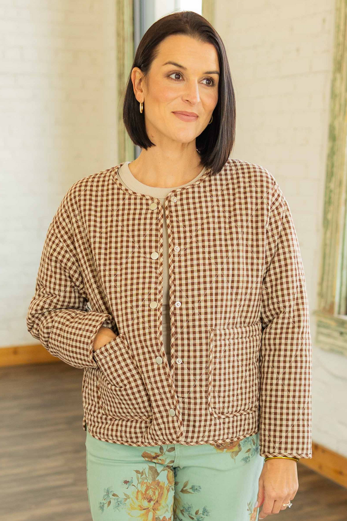 Kandace wearing the Julieta gingham puff snap button jacket in brown and cream checkered print, styled with mint floral pants
