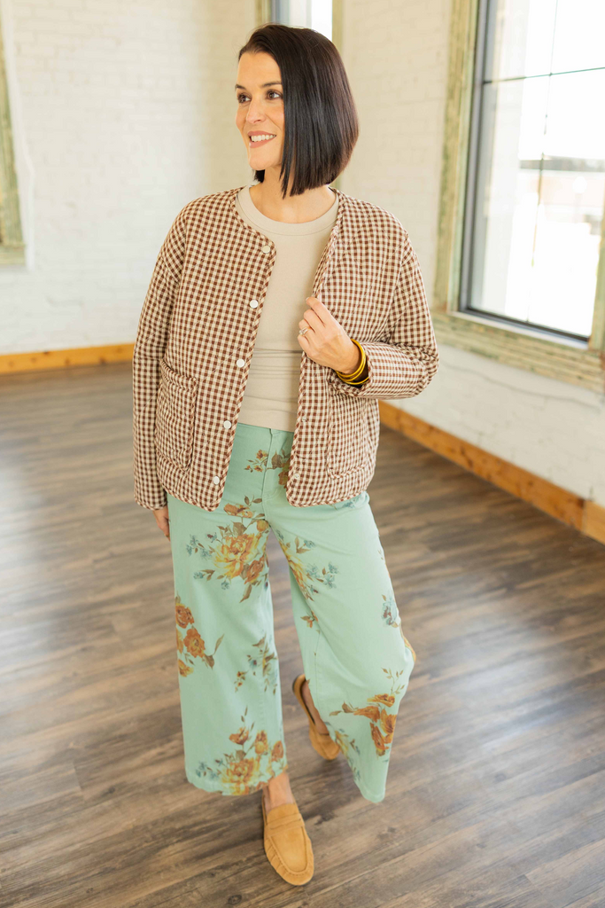 Kandace wearing the Julieta gingham puff snap button jacket in brown and cream checkered print, styled with mint floral pants