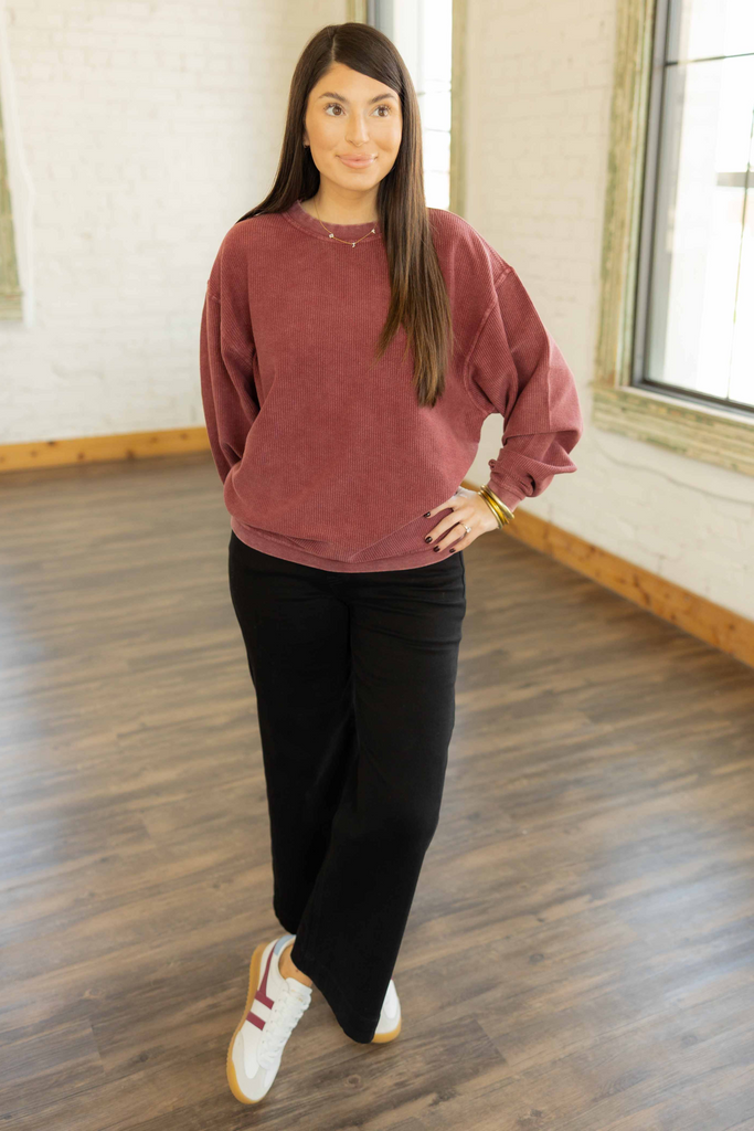 Kayla wearing the Mandie Corded Crewneck in faded maroon with relaxed black pants